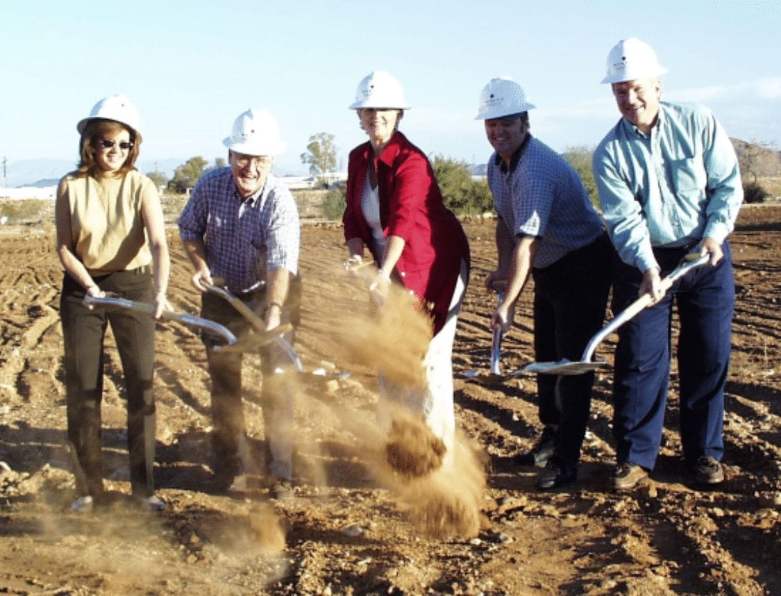 A group of people at the Cerebral Palsy of Arizona pediatric therapy center holding shovels.