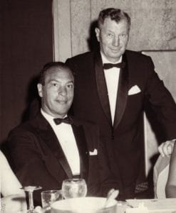 Black and white photo of a man and woman in tuxedos attending a home and community based services event.