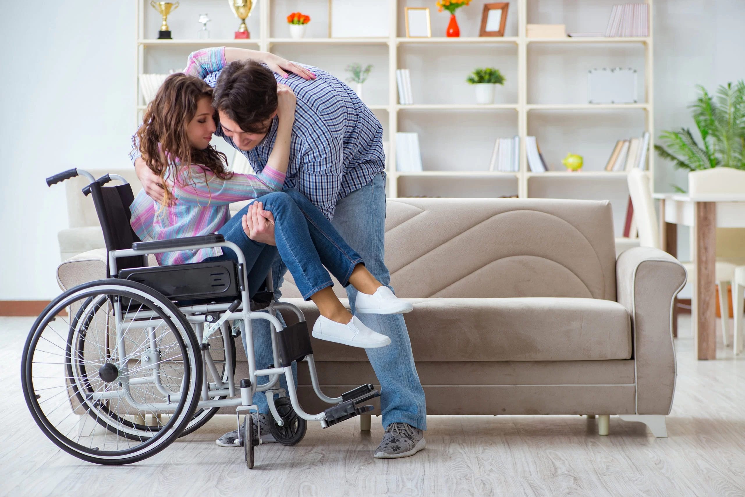 A man and woman in a wheelchair hugging each other at Cerebral Palsy of Arizona's early learning center during a pediatric therapy session.