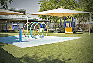 A pediatric therapy facility offering home and community-based services to children with cerebral palsy of Arizona, equipped with a slide and swings.