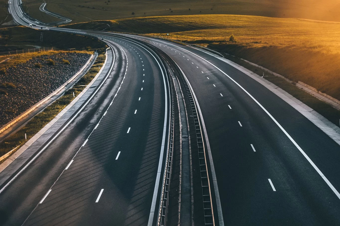 An aerial view of a highway at sunset.