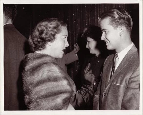 An old photo of a man talking to a woman at the pediatric therapy center.