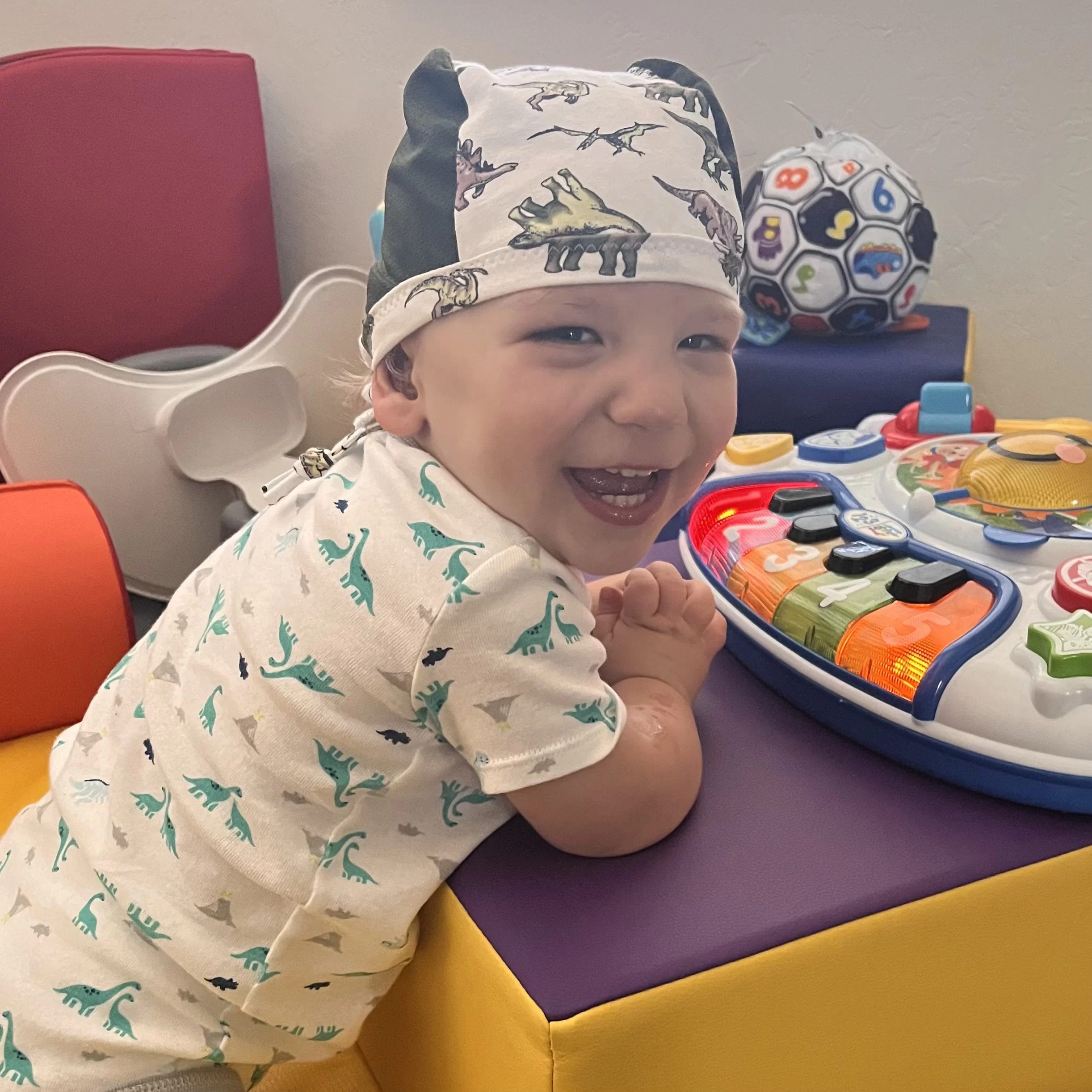Keywords: pediatric therapy, early learning centerA baby engages in pediatric therapy and early learning at an early learning center while playing with a toy.