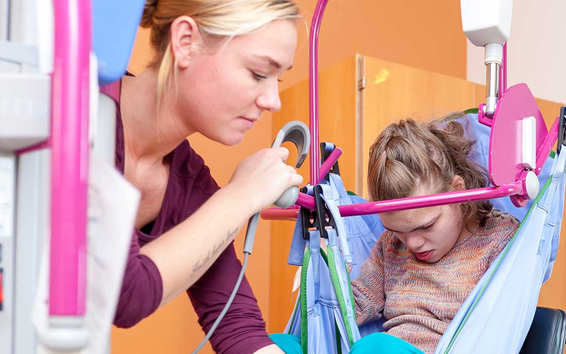 A young girl with cerebral palsy of Arizona is sitting in a chair with a stethoscope.